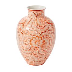 an orange and white vase with flowers on it