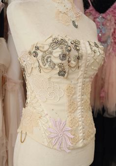 a mannequin is adorned with beaded and sequins on it's sides