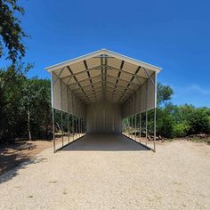 a large metal building with lots of windows on the front and side walls that are open