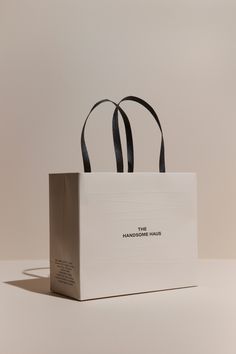 a white shopping bag sitting on top of a table