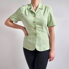 Beautiful, apple green blouse with a v-neckline collar. It has a fitted shape, short sleeves and a four large button fastening. It is made from brushed, soft and velvety to touch fabric. Perfect on its own or could be worn as a summer blazer with a t-shirt underneath. Made Rebecca Sheldon At New Look. 70% modal, 30% polyester. Labelled as 12UK, 40FR. Measurements when laid flat are: Pit to pit: 49cm  Waist: 40cm Length: 63cm  Excellent condition. B. Fitted Green Blouse With Button Closure, Green V-neck Shirt With Button Closure, Green Short Sleeve Office Blouse, Green Shirt With Button Closure And Collared Neckline, Green Short Sleeve Blouse For Office, Green Collared Top For Office, Classic Blouse With Johnny Collar And Button Closure, Fitted Green Office Shirt, Fitted Green Shirt For Work