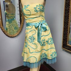 Strapless Cocktail Party Dress In Yellow With Teal Blue Ribbon Embroidery All Over And Matching Tulle Trim At Hem By Jessica Mcclintock. Tagged Size 4. See Measurements For A Good Fit: Chest 14.5" Flat, Length 21" From Waist, Waist 13.5" Flat Good Used Condition. One End Of Satin Ribbon Belt Shows Fraying, Visible In Final Picture. Discounted Accordingly. See Photos For Details. Please Comment Below With Any Questions. *Many Of Our Items Come From Estate Sales Or Other Sources, Which Means We Do Fitted Yellow Mini Dress For Prom, Yellow Fitted Mini Dress For Prom, Yellow Fitted Strapless Dress For Spring, Fitted Yellow Dress For Homecoming, Yellow Fitted Dress For Homecoming, Fitted Yellow Homecoming Dress, Yellow Strapless Mini Dress For Spring, Yellow Mini Dress For Spring Wedding, Spring Wedding Yellow Mini Dress