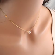 "This simple choker necklace is so elegant, and great for layering with other chains. A creamy ivory real freshwater pearl is centered on lightweight, gold filled chain. This beautiful pearl is a rounded teardrop shape, which is a nice departure from the more typical round. Tiny white pearls connect the lobster clasp. This white floating pearl necklace is great for bridesmaids too! Prefer silver or rose gold? Please choose your preferred metal at checkout, and I will make one just for you! The r Minimalist Gold Pearl Choker, Minimalist Pearl Chain Choker, Minimalist Pearl Charm Choker, Minimalist Gold Choker With Pearl Drop, Minimalist Pearl Choker With Pearl Pendant, Minimalist Gold Choker With Pearl Chain, Gold Minimalist Choker With Pearl Chain, Simple Gold Pearl Necklace With Clavicle Chain, Dainty Gold Choker With Pearl Drop