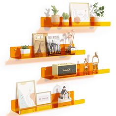 two orange shelves with pictures and cards on them