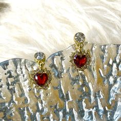 Absolutely stunning red heart ruby dangle drop stud earrings in 14K Gold filled finish, romantic heart shaped ruby birthstone dangle, with sparkly lace diamond cz stones surrounded. Beautiful burgundy gemstone gives classy, vintage and timeless glittery. It goes well with everyday/occasions/bridal or bridesmaid look, easily elevate your outfit. Also a perfect Valentine's Day/wedding bridesmaid bridal/birthday gifts idea to show your love! ♥ All of our jewelry are carefully handmade with delicate and exquisite details, all designed and made in Manhattan, New York. 💎 Features: ♥ Material: Finest 14K Gold Filled ♥ Main stone: Ruby Cubic Zirconia ♥ Side Stone: Cz crystal ♥ Push Back Closure 💎 Details: ♥ Approximate Measurements: - Length: 0.75" - Width: 0.45" ♥ Lightweight, easy to wear ♥ Ni Heart Shaped Birthstone Earrings For Wedding, Heart-shaped Birthstone Earrings For Wedding, Red Heart Drop Earrings For Wedding, Red Drop Heart Earrings For Wedding, Ruby Earrings For Valentine's Day Anniversary, Red Heart Pendant Earrings For Anniversary, Ruby Earrings For Anniversary On Valentine's Day, Red Dangle Heart Earrings For Wedding, Red Heart Earrings For Wedding