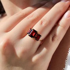 💎 Fortune 14K Solid Gold Lunar Red Natural Garnet Diamond Three Stone Ring *Metal: 14K Solid Gold *Gemstone:    - **Garnet     - Cut: Emerald-Cut      - Color: Red      - Clarity: Eye-Clean      - Size: 1 Piece 7 x 9 mm, 2 Pieces 5 x 7 mm      - Total Carat Weight (CTW): 5.30 *Diamonds:    - Color: Gold    - Clarity: VS    - Total Carat Weight (CTW): 0.03 💓 Why You'll Love It: The Fortune Lunar Red Garnet Three Stone Ring is a captivating blend of rich color and timeless elegance. Featuring a Fine Jewelry Red Ruby Three Stone Ring, Formal Red Three Stone Rings, Elegant Three Stone Ruby Ring Gift, Elegant Red Three Stone Birthstone Ring, Elegant Red Three-stone Birthstone Ring, Fine Jewelry Garnet Ring, 14k Gold Red Ruby Ring Fine Jewelry, Elegant Red Birthstone Ring With Gemstone Accents, Red Heirloom Jewelry With Gemstone Accents