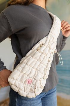 Elevate your accessory game with The Quilted Sling Bag in Ivory. Designed for women, this quilted sling bag combines elegance and functionality, making it the perfect addition to your wardrobe. The soft, quilted texture offers a luxurious feel, while the pink Palmr logo adds a playful touch of sophistication. Imagine carrying this chic ivory crossbody bag, effortlessly complementing your outfit while keeping your essentials organized and within easy reach. Lifestyle Fit The Quilted Sling Bag in White Quilted Shoulder Bag For Travel, White Quilted Shoulder Bag For Everyday Use, Versatile Quilted Beige Bag, Cream Quilted Shoulder Bag For Everyday Use, Everyday Quilted Cream Shoulder Bag, Everyday Cream Quilted Shoulder Bag, White Quilted Crossbody Shoulder Bag, Cream Quilted Travel Bag, Beige Quilted Crossbody Bag