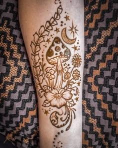 a woman's leg with hendix and flowers on it