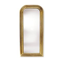 a gold framed mirror against a white wall