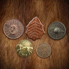 four different types of coins sitting on top of a fur covered surface