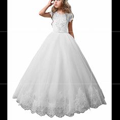 Cap Sleeves,Buttons At Back This Beautiful White Girl Dress Is Perfect For A Flower Girl Dress,First Communion Dress,Pageant Dress,Birthday Party Dress,Holiday,Formal Dresses For Girls Or Any Other Special Occasions If You Need This Dress To Be More Puffy, Please Get A Petticoat For Your Child White Sleeveless Ball Gown For First Communion, White Tulle Pageant Dress For First Communion, White Lace Trim First Communion Dress For Pageant, Princess Style White First Communion Dress With Ruffles, White Communion Dress, White First Communion Dress, Tulle Skirt, Ball Gown Shape, Holiday Formal Dresses, Cute White Dress, Girls White Dress