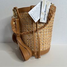 Nwt Tommy Bahama Rattan Bucket Bag Color Tan See Measurements For Size Also Available In Cream Color, Black, Tan Message For Color Availability Vacation Leather Bags With Gold-tone Hardware, Vacation Leather Shoulder Bag With Gold-tone Hardware, Travel Crossbody Bucket Bag With Bamboo Handle, Leather Bags With Gold-tone Hardware For Vacation, Leather Shoulder Bag With Gold-tone Hardware For Vacation, Natural Bucket Bag With Gold-tone Hardware, Vacation Straw Bag With Leather And Gold-tone Hardware, Summer Travel Bucket Bag With Gold-tone Hardware, Vacation Bucket Bag With Gold-tone Hardware