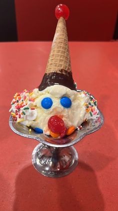 an ice cream sundae topped with whipped cream, candy and sprinkles