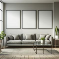 a living room with three pictures on the wall