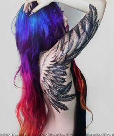 a woman with colorful hair and tattoos on her back