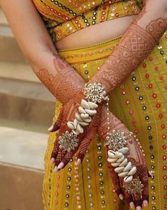 a close up of a woman's hands with hennap and jewelry on