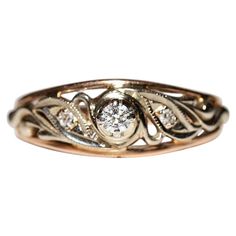 a gold and diamond ring on a white background