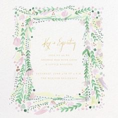 a wedding card with watercolor flowers and greenery in the center, on white paper