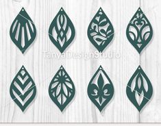 paper cut designs with leaves and flowers on white wooden background - free image 34971