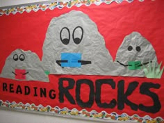 a bulletin board with rocks and grass on it that says reading rocks written in black