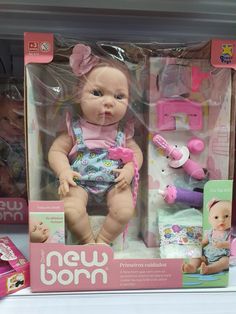 a new born doll in its box on display at a toy store with other toys