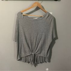 Oversized Knit T Shirt From A Boutique With Some Really Cute Details. It Ties In The Front And Has Wooden Buttons Up The Back. It Is Size Small But It Fits Very “Oversized”. In Brand New Condition Trendy Short Sleeve Knit Top For Loungewear, Oversized Cotton Short Sleeve Knit Top, Oversized Cotton Knit Top With Short Sleeves, Casual Oversized Short Sleeve Knit Top, Casual Gray Short Sleeve Top, Gray Cotton Crew Neck Knit Top, Gray Crew Neck Cotton Knit Top, Gray Casual Tops For Layering, Gray Short Sleeve Knit Top For Spring