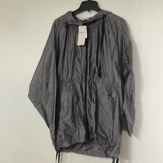 New With Tag. Gray Long Sleeve Windbreaker For Spring, Gray Hooded Raincoat For Fall, Oversized Long Sleeve Spring Parka, Oversized Spring Parka, Oversized Hooded Spring Windbreaker, Oversized Hooded Windbreaker For Spring, Oversized Spring Parka For Workwear, Oversized Spring Workwear Parka, Oversized Long Sleeve Casual Raincoat