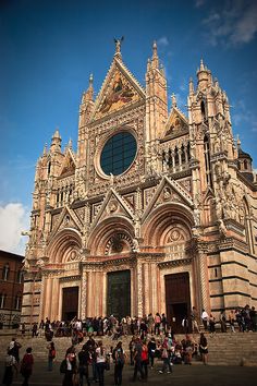 people are standing in front of an old church