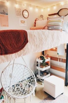 a room with a bed, chair and other items on the wall above it that is decorated with string lights