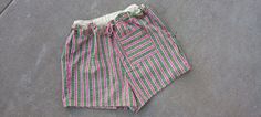 These are x-large drawstring cotton shorts.  The print on the shorts are stripes with pictures of flowers within the stripes.  The drawstring on the shorts is made of hemp.  This garment can be machine-washed and dry on low.   Shorts Measurements: Waist: 42" (drawstring) Hips: 46" Length: 16" Inseam: 3" If you have any questions or would like to see additional pictures, please do not hesitate to contact our shop. Thank you for your time. Cotton Beach Shorts With Drawstring, Beach Cotton Shorts With Drawstring, Green Relaxed Fit Cotton Pajama Shorts, Green Cotton Pajama Shorts, Striped Cotton Shorts With Pockets, Green Cotton Pajama Shorts With Elastic Waistband, Summer Cotton Shorts With Drawstring, Striped Cotton Beachwear Bottoms, Green Cotton Pajama Shorts For Summer