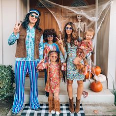 the family is dressed up for halloween outside