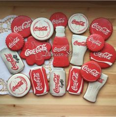 coca - cola cookies are laid out on a doily to be used as decorations