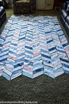 an area rug made out of strips of paper on the floor in a living room