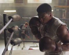 a man standing in front of a boxing ring