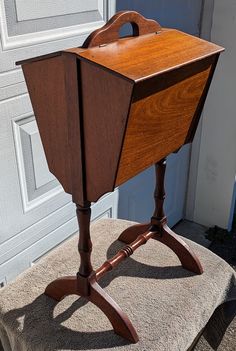 an old fashioned wooden table sitting on top of a cushion