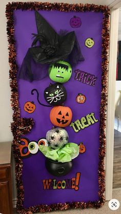 a purple door decorated with halloween decorations