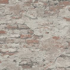 an old brick wall that has been painted white and red with some brown spots on it