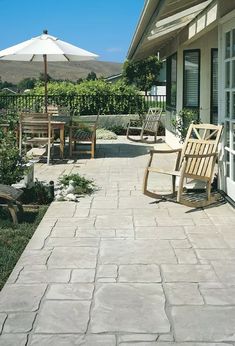 a patio with chairs and an umbrella on it