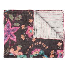 the black and pink floral pocket square is folded on top of another piece of fabric