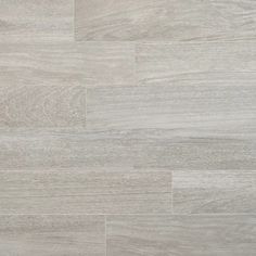 a white and grey tile floor with wood grains