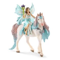 a figurine of a fairy riding a white horse with flowers on its back