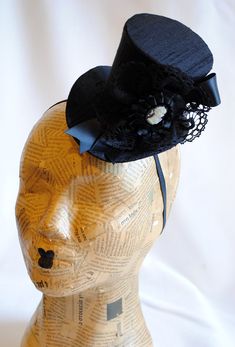 This victorian goth mini top hat is a simple yet elegant piece.It is covered with black silk shantung and adorned with black satin ribbon in a vertical half bow, vintage black cotton lace in a rosette, pleated satin ribbon, which forms an oval frame for a beautiful black and white victorian profile cameo. Choose between with or without black veil. Also available in a white and black combination: https://www.etsy.com/bizarrenoir/listing/166826619/gothic-mini-top-hat-in-purple-velvet?ref=shop_home Gothic High Crown Costume Hat, Handmade Fitted High Crown Mini Hats, Handmade Fitted Mini Hat With High Crown, Gothic Black Brimmed Costume Hat, Gothic Fitted High Crown Costume Accessories, Gothic Fitted Hat With Short Brim, Gothic Top Hat With Short Brim For Halloween, Fitted Witchy Party Hat, Witchy Fitted Party Hat