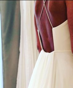 the back of a woman's white wedding dress