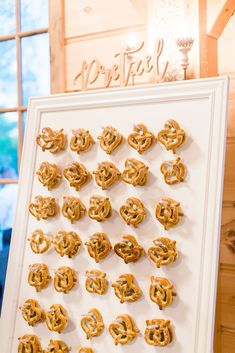 pretzels are arranged in the shape of hearts on a white framed display board