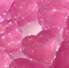 many pink heart shaped boxes with sparkles on them