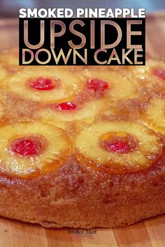 a pineapple upside down cake sitting on top of a wooden cutting board with the words smoked pineapple upside down cake