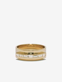 a yellow gold wedding band with baguettes on the side and channeled diamonds