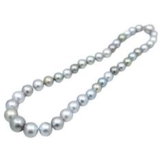 A BUNDA strand of baroque-shaped Cultured Tahitian pearls, strung knotted with an 18 carat white gold clasp. The 39 pearls range in size from 8.5mm up to 14.8mm, featuring colours of green, yellow, green, white, pink, and various shades of silver-blue and have a clean skin and an excellent lustre. Total Length - 44cm Tahitian Pearl Bracelet, Pearl Strands Necklace, Pearl And Diamond Necklace, Tahitian Black Pearls, Bezel Set Diamond, Modern Necklaces, Pearl Strands, Tahitian Pearls, Pearl Diamond