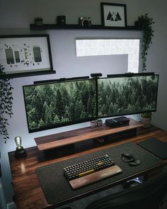 a desk with two monitors and a keyboard on it