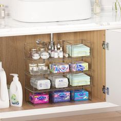 a bathroom cabinet filled with lots of toiletries and soaps next to a sink